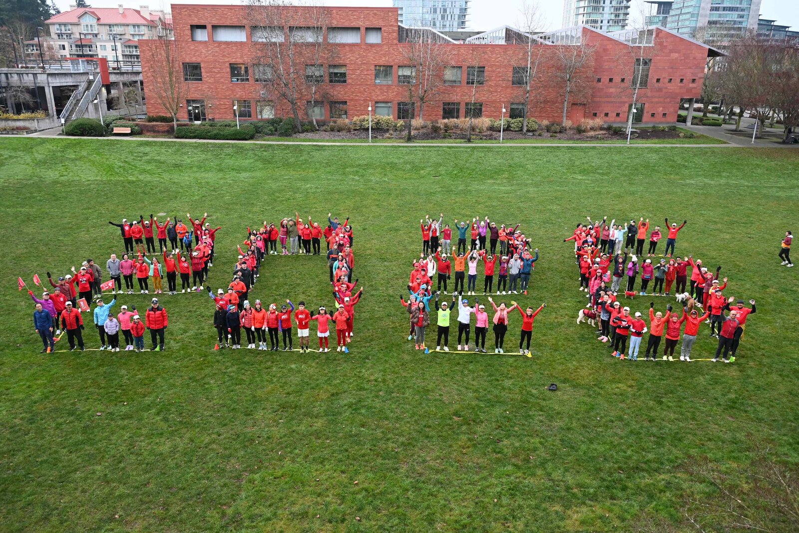 Seattle United Runners members forming SU10 on a lawn for the club's tenth anniversary
